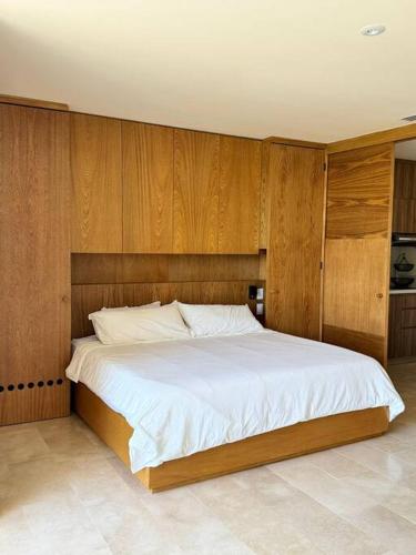 a bedroom with a large bed with wooden walls at zantamar ixchel in Cruz de Huanacaxtle