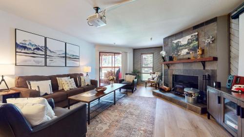 a living room with a couch and a fireplace at Aspen Creek #115 in Mammoth Lakes