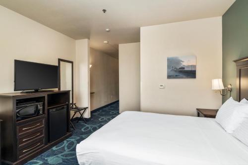 a hotel room with a bed and a flat screen tv at Park Point Marina Inn in Duluth