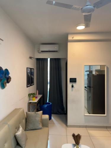 a living room with a couch and a refrigerator at Raintree in Bengaluru