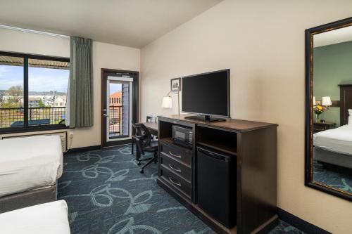 a hotel room with a bed and a television at Park Point Marina Inn in Duluth