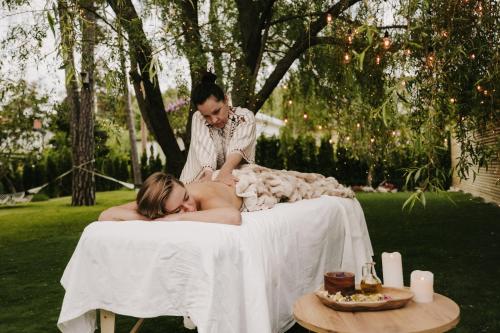 a woman laying on a white table with a man at Privat Spirit Spa Villa in Vallentuna