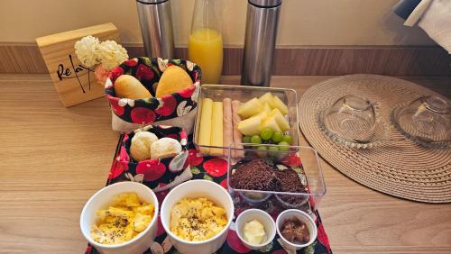 a tray filled with different types of food on a table at Chalés Vila do Moinho in Monte Verde