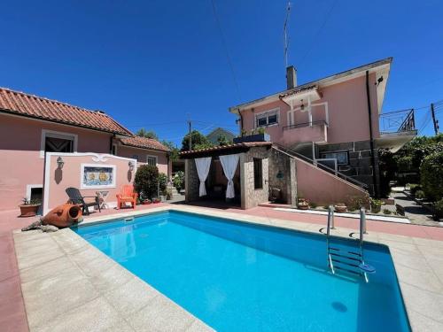 a swimming pool in front of a house at Casa da Serra - Gerês in Terras de Bouro