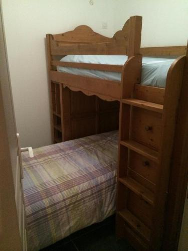 a bedroom with two bunk beds and a dresser at La Cucumelle in La Salle-les-Alpes