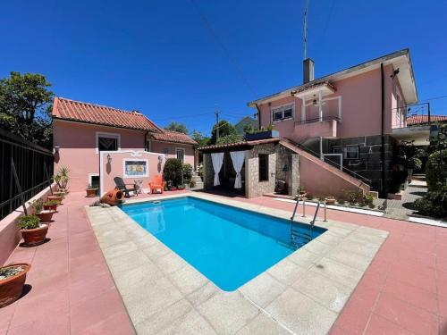 a swimming pool in front of a house at Casa da Serra - Gerês in Terras de Bouro
