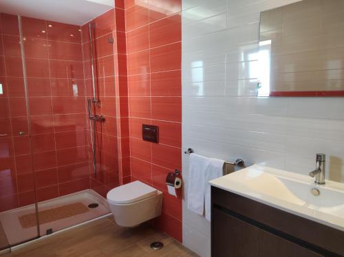 a bathroom with a toilet and a sink and a shower at MONTE s PEDRO in Lagos