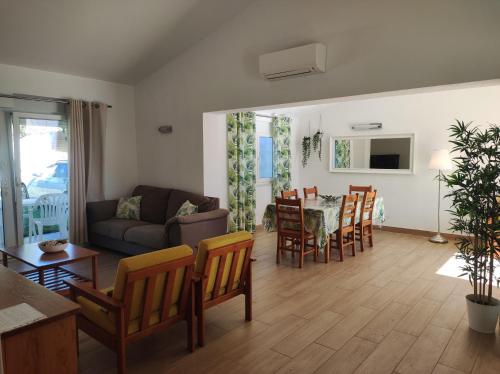 a living room with a couch and a table and chairs at MONTE s PEDRO in Lagos