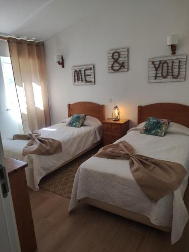 a bedroom with two beds and a room with a window at MONTE s PEDRO in Lagos