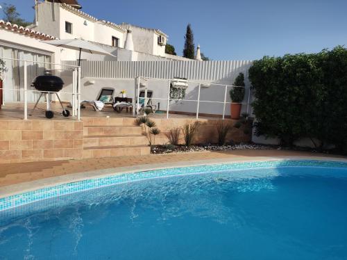 a large blue swimming pool in front of a house at MONTE s PEDRO in Lagos