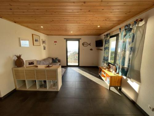 a living room with a wooden ceiling at Longitude 31 House in Faja Grande