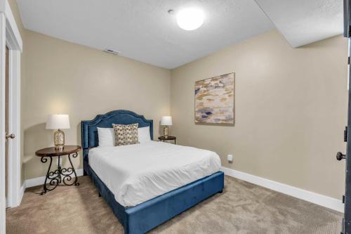 a bedroom with a blue bed and a table at Charming 3BR-Near Skiing & Hiking in Kamas
