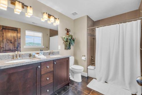 a bathroom with a sink and a toilet and a shower at Charming 3BR-Near Skiing & Hiking in Kamas