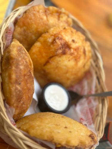 a basket with food in it with dipping sauce at Tayrona Angel Lodge in El Zaino