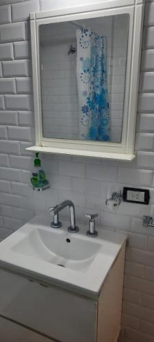 a bathroom sink with a medicine cabinet and a mirror at Hermoso departamento en Palermo muy luminoso in Buenos Aires