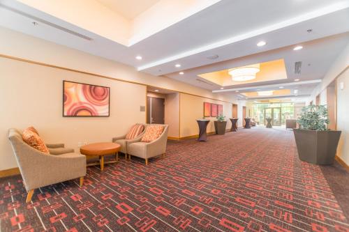 a lobby of a hospital with chairs and tables at Hyatt Place Houston/The Woodlands in The Woodlands