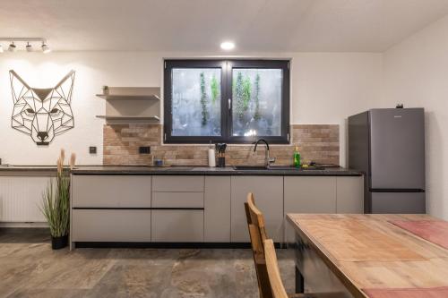 a kitchen with a sink and a table and a window at Luxury villa with a parking space Kupjak, Gorski kotar - 23066 in Kupjak