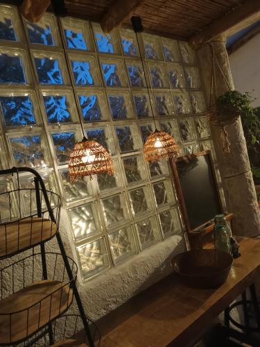 a room with two chandeliers and a mirror at Guesthouse Un Poco Mas in Canillas de Aceituno