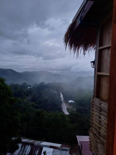 a room with a view of a river in the mountains at KHIRI HOUSE &Café Farm ดอยช้างเชียงรายที่พักอาข่าเรียวกังสไตล์กลางหมู่บ้านดอยช้าง in Ban Rong Than