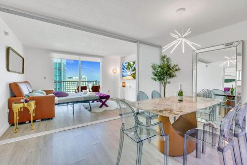 a dining room and living room with a table and chairs at Oceanside Penthouse Apartment in Brickell Miami, Pool, Free Parking in Miami