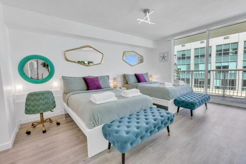 a bedroom with two beds and two chairs at Oceanside Penthouse Apartment in Brickell Miami, Pool, Free Parking in Miami