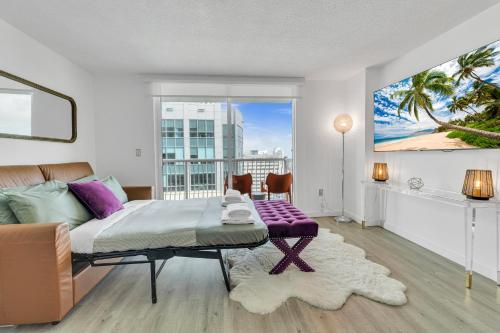 a bedroom with a king sized bed and a large window at Oceanside Penthouse Apartment in Brickell Miami, Pool, Free Parking in Miami