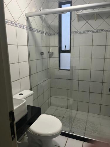 a bathroom with a shower with a toilet and a sink at Life Flats Temporada com Bela vista à 50m da Praia in Recife