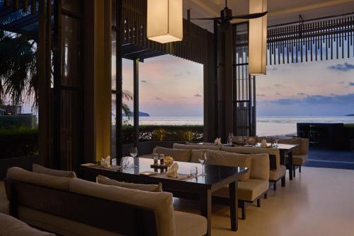a restaurant with tables and chairs and a view of the ocean at The Chill Resort and Spa, Koh Chang in Ko Chang