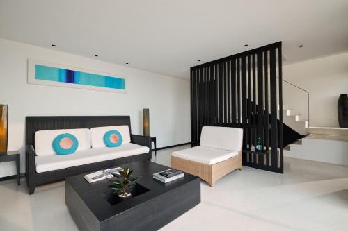 a living room with a couch and a chair at The Chill Resort and Spa, Koh Chang in Ko Chang