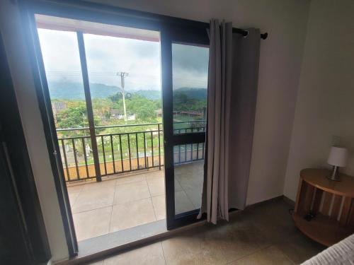 a room with a large sliding glass door with a balcony at Hermosos apartamentos in Ríoverde