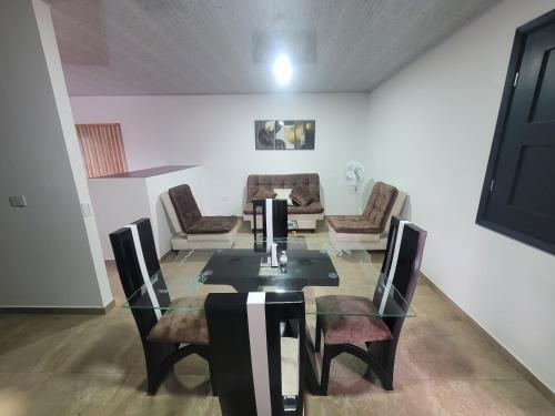 a dining room with a glass table and chairs at Hermosos apartamentos in Ríoverde