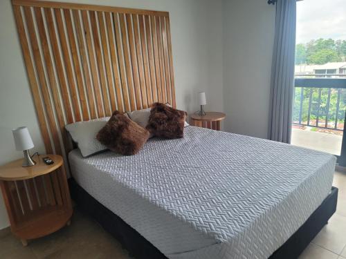 a bedroom with a bed with two stuffed animals on it at Hermosos apartamentos in Ríoverde