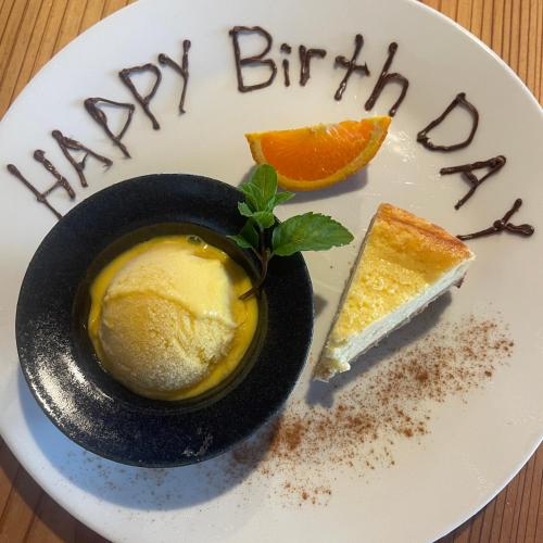 a plate with a happy birthday dessert with an orange slice at ATASHIKADAYS Kumano-Kodo Beachfront B&B Hostel in Kumano
