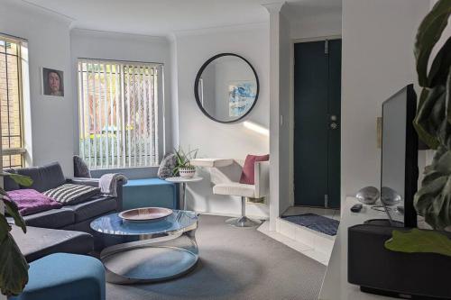 a living room with a couch and a table at Ocean Villa in Perth