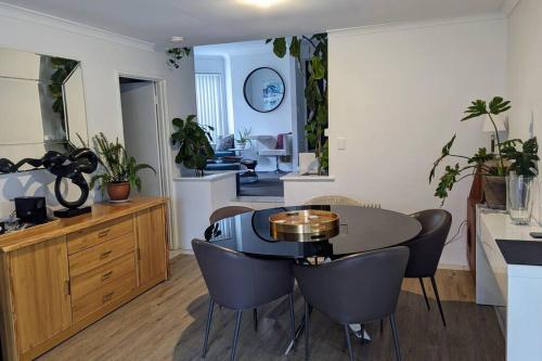 a kitchen and dining room with a table and chairs at Ocean Villa in Perth
