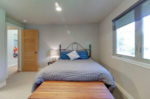 a bedroom with a bed and a window at Serendipitous-AC, Hot Tub, Big Fenced Yard, 2 Master Suites, in Bend