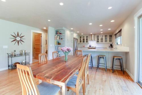 a kitchen and dining room with a wooden table and chairs at Serendipitous-AC, Hot Tub, Big Fenced Yard, 2 Master Suites, in Bend
