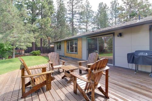 a deck with three wooden chairs and a table at Serendipitous-AC, Hot Tub, Big Fenced Yard, 2 Master Suites, in Bend