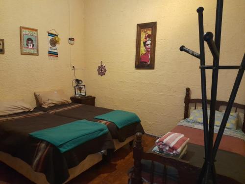 a bedroom with two beds and a microphone at El Patio de la Morocha in Montevideo