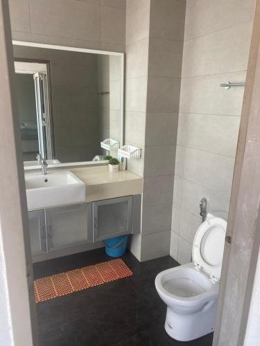 a bathroom with a toilet and a sink and a mirror at Ubays Zetepark House in Kuala Lumpur