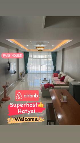a living room with a couch and a table at Pani House ( Hatyai 3 ) in Hat Yai