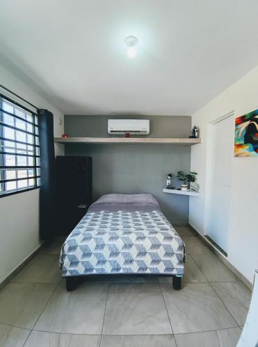 a bedroom with a bed in a room at Departamentos Caracoles Miramar in Ciudad Madero