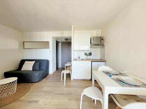 un salon avec un canapé et une table dans l'établissement Canet-en-Roussillon T2 Moderne - Parking - Clim - 2ème étage avec ascenseur - 4 pers - FR-1-794-136, à Canet