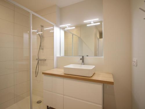 a white bathroom with a sink and a shower at Bel Apt T3 rénové avec terrasse et wifi, centre La Bourboule, proche thermes, max 5 pers - FR-1-608-270 in La Bourboule