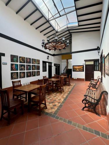a dining room with wooden tables and chairs at Hotel Boutique San Antonio in Cali