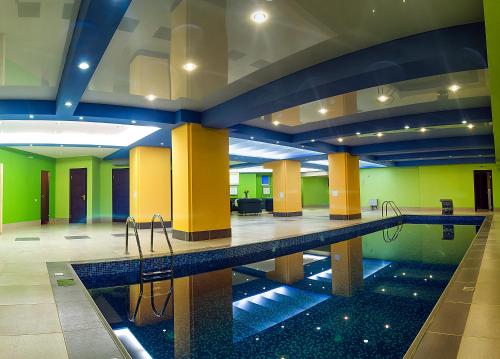a large swimming pool in a large building with a pool at Business Hotel Europa in Khabarovsk