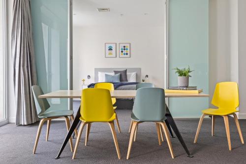 a dining room with a table and four chairs at The Mark on Collins in Melbourne