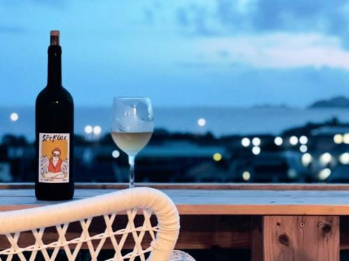 a bottle of wine and a glass on a table at and SEA The Terrace 海を感じながら料理を楽しみ開放的なTerraceで過ごす in Kamogawa