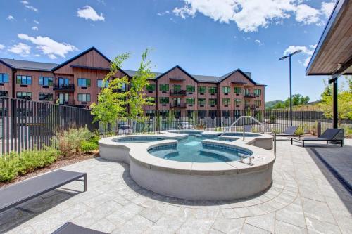 a hot tub in a patio with a building at Black Rock Ridge 14488 by Moose Management in Park City