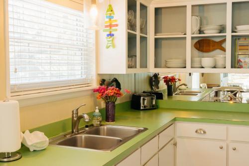 a kitchen with green counter tops and a sink at Moon Baby in Santa Rosa Beach